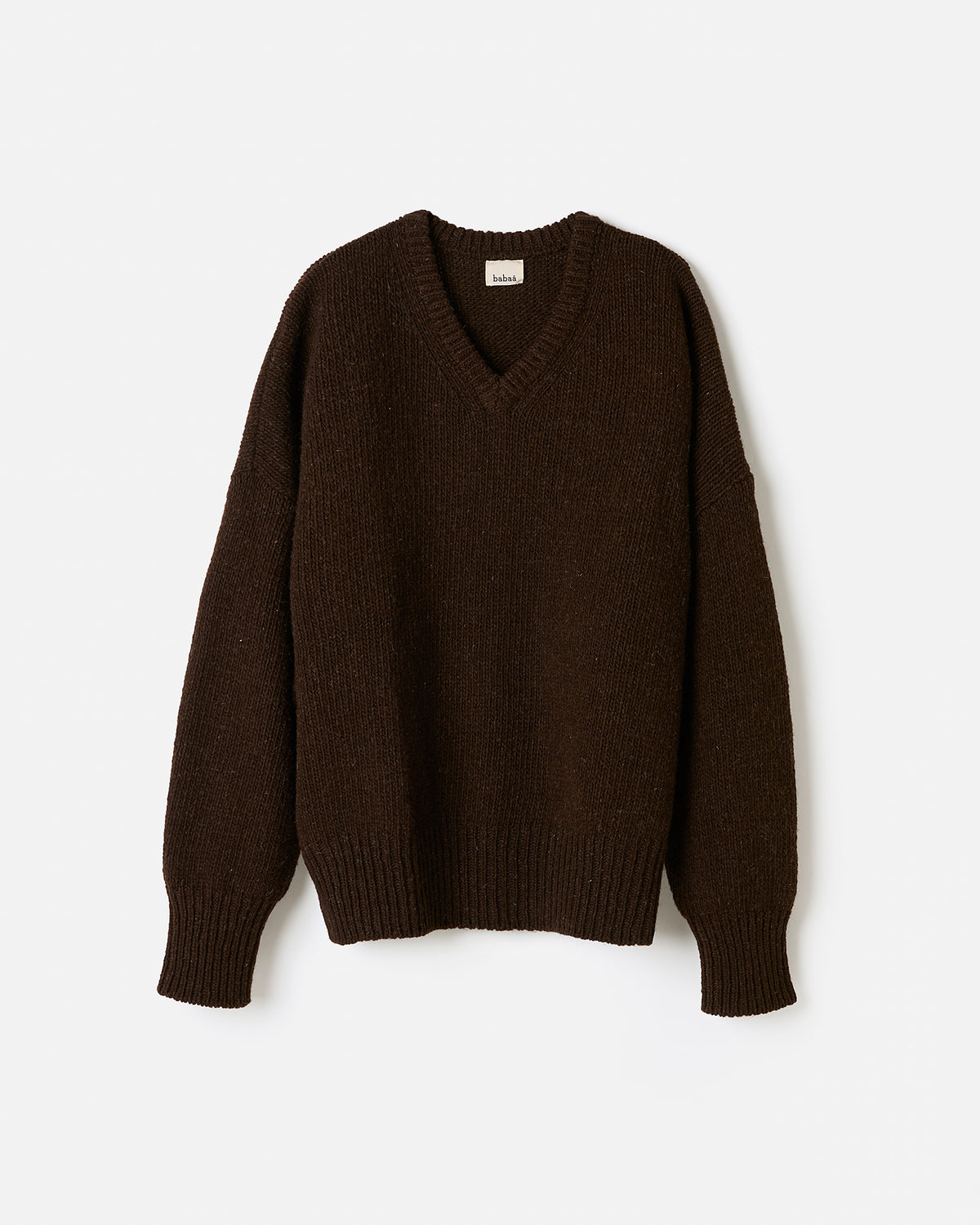 Silhouette of a woman wearing the Babaà No97 Earth jumper, showcasing the relaxed fit and earthy tone of the knit sweater.