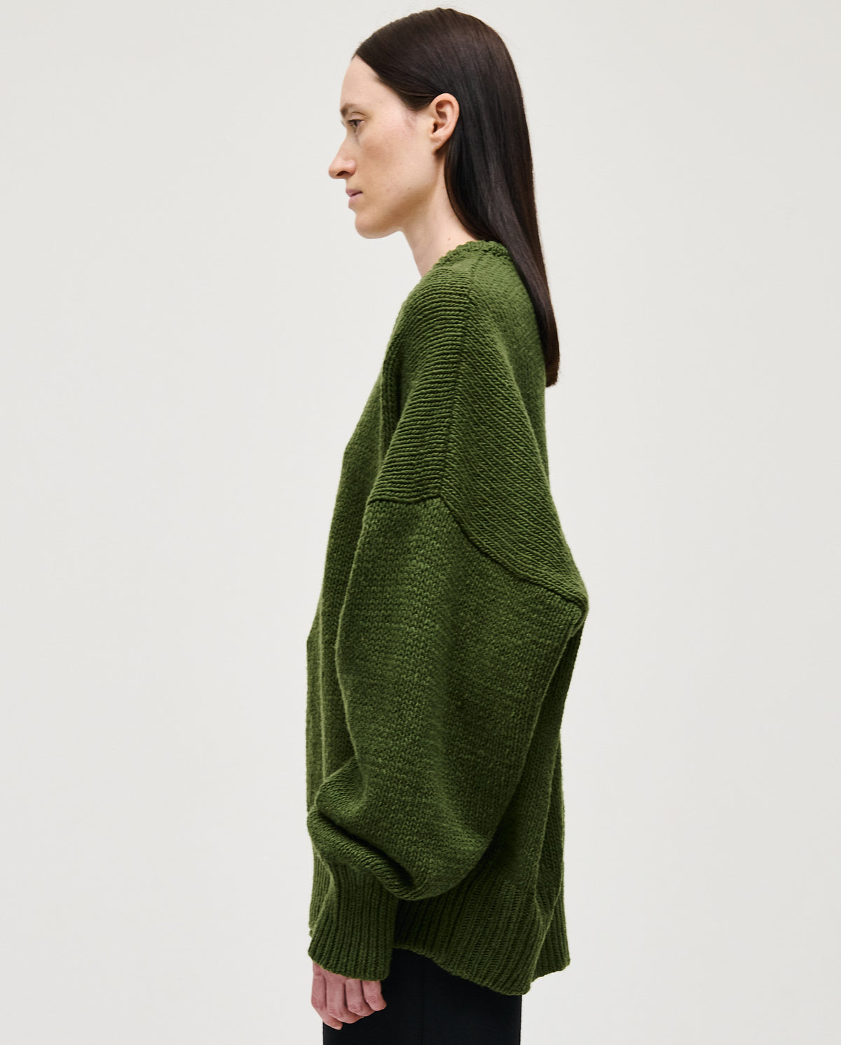 Babaà No97 Forest jumper worn by a woman, featuring a cozy knit design in forest green, suitable for fall and winter.