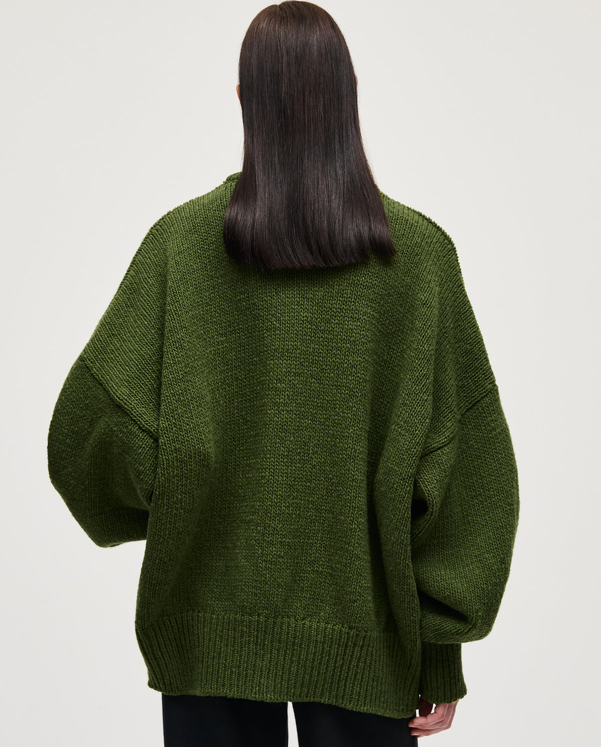 Babaà No97 forest jumper worn by a woman, featuring a cozy knit design in forest green, styled casually.