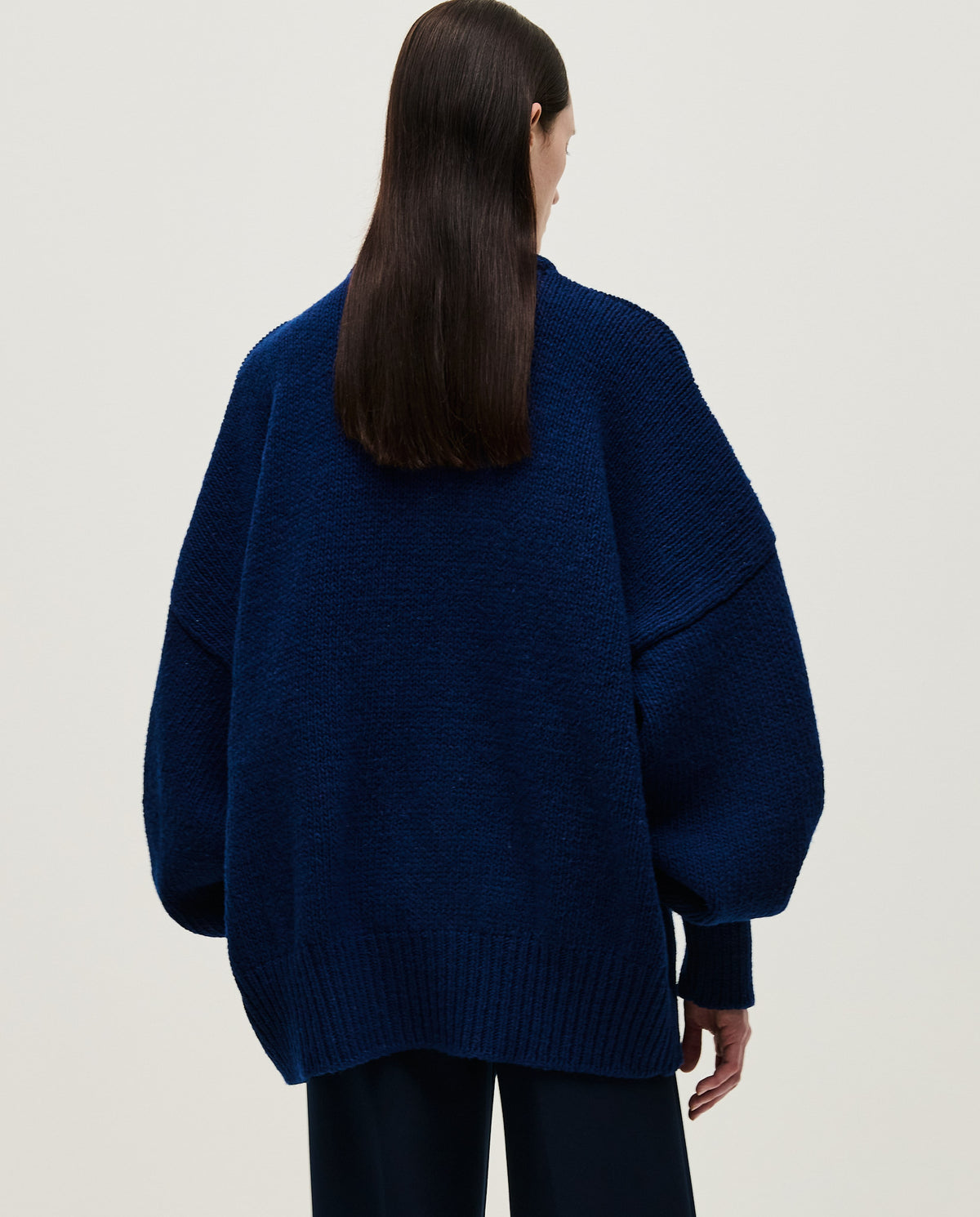 Navy jumper No97 by Babaà worn by a woman, featuring a comfortable fit and soft fabric, styled casually.