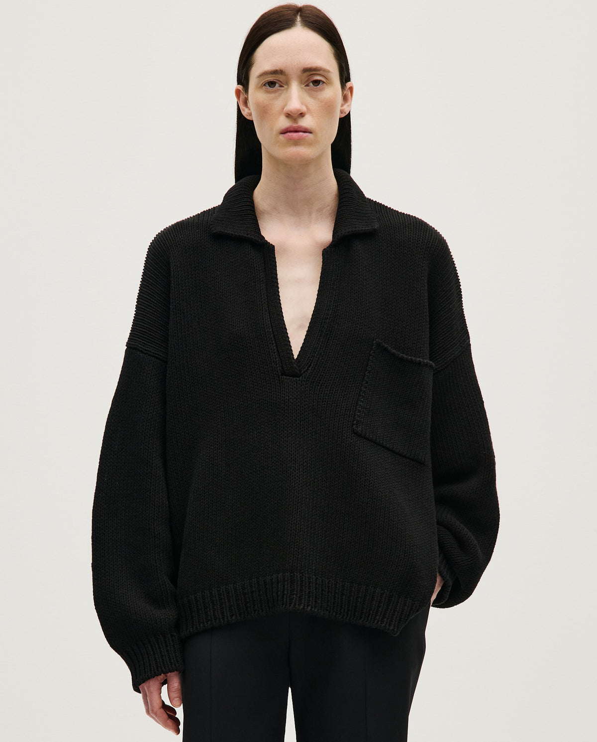 Black Babaà Polo No1 women's shirt, featuring a classic collar and short sleeves, displayed on a white background.