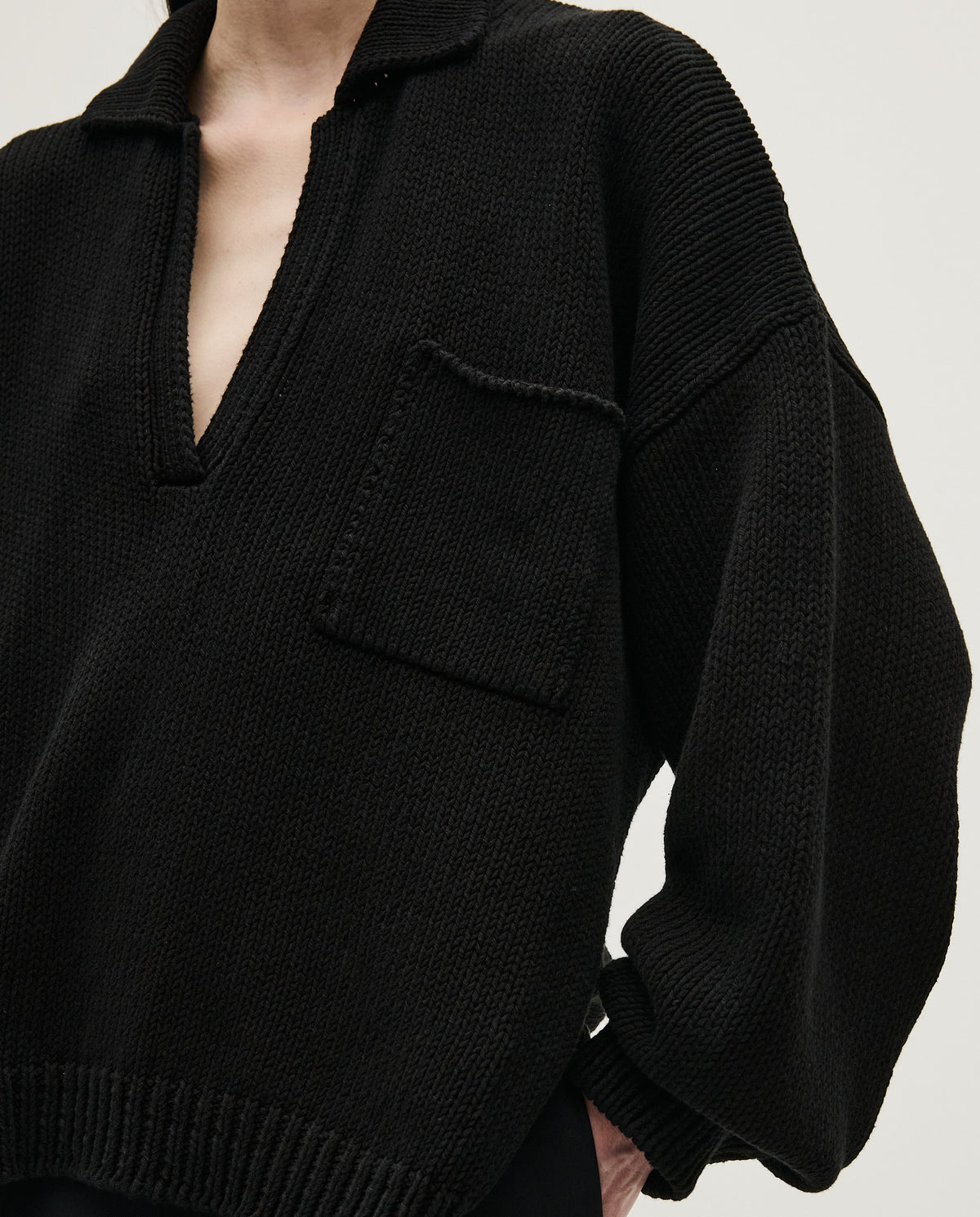 Black Babaà Polo No1 for women, close-up of the classic collared shirt with buttons and soft fabric.