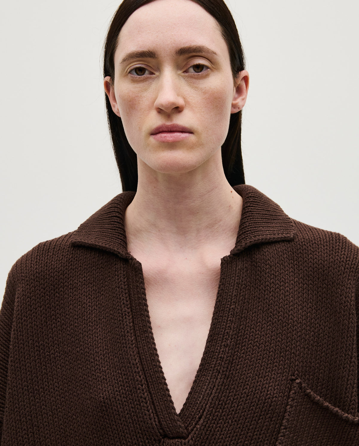 Woman wearing Babaà Polo No1 Husk in a casual style, showing the textured husk fabric and classic polo design.