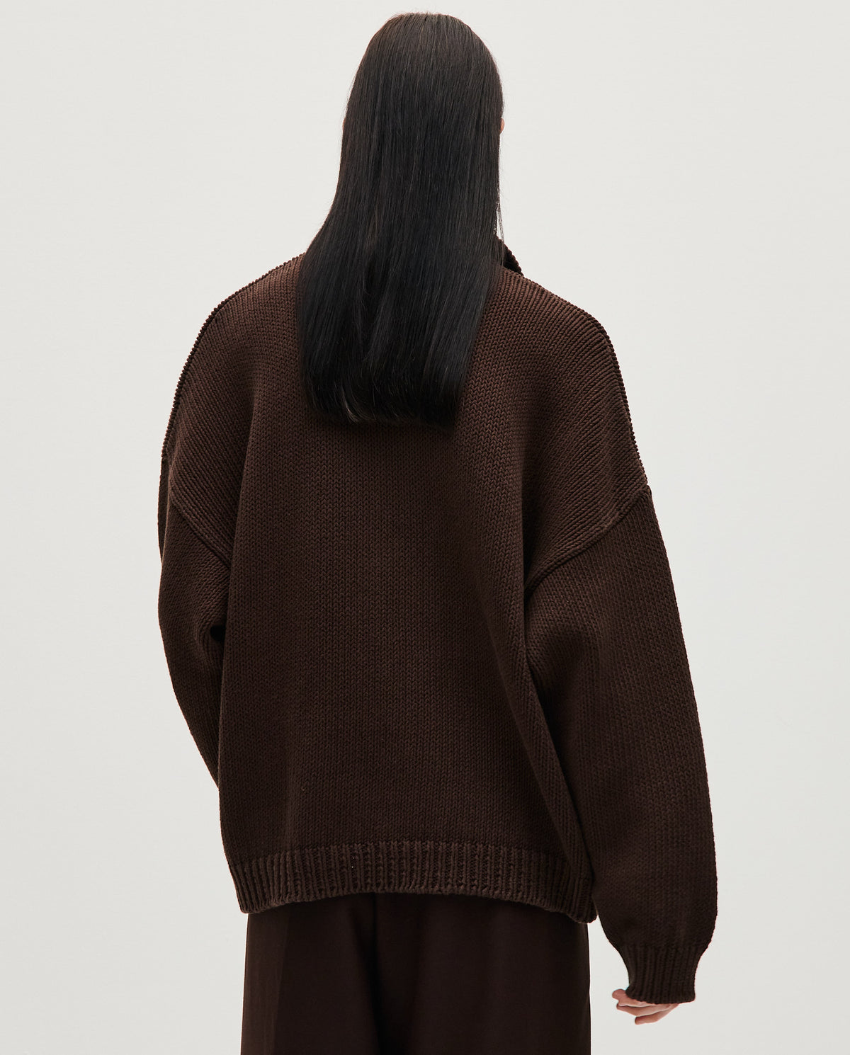 Woman wearing a Babaà Polo No1 Husk in a stylish, casual fit with a soft fabric texture and classic polo collar.