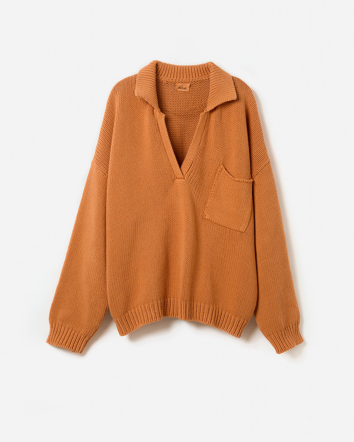 Silhouette of a woman wearing a Babaà Polo No1 Persimmon shirt, showcasing its vibrant color and classic fit.