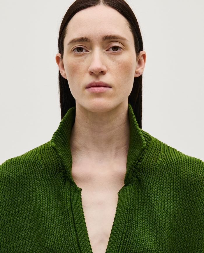 Woman wearing Babaà Polo No1 Pine in natural fabric, showcasing the tailored fit and classic design of the men's polo style.