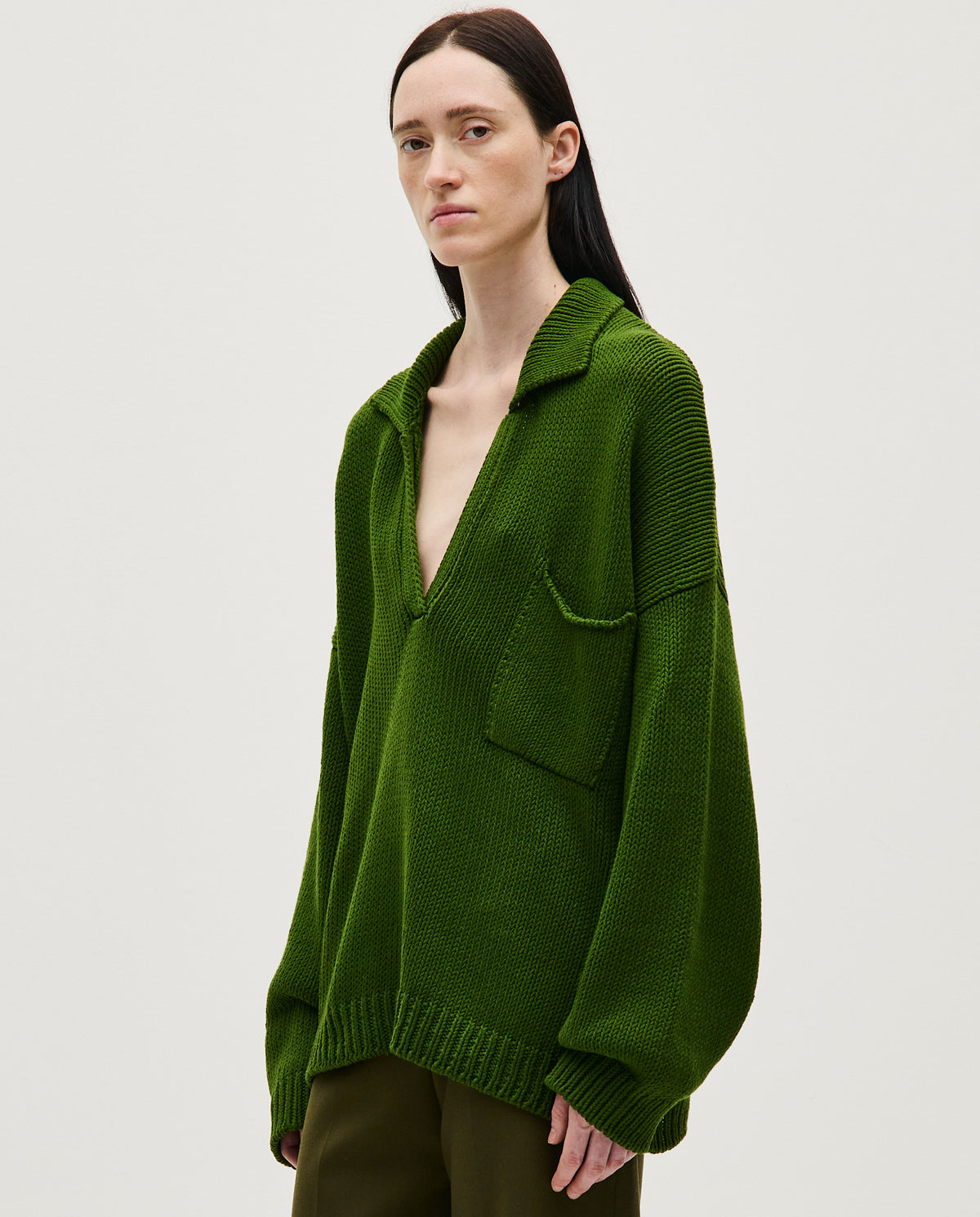 Woman wearing a Babaà Polo No1 Pine in a casual fit, showcasing the classic design and green pine color.