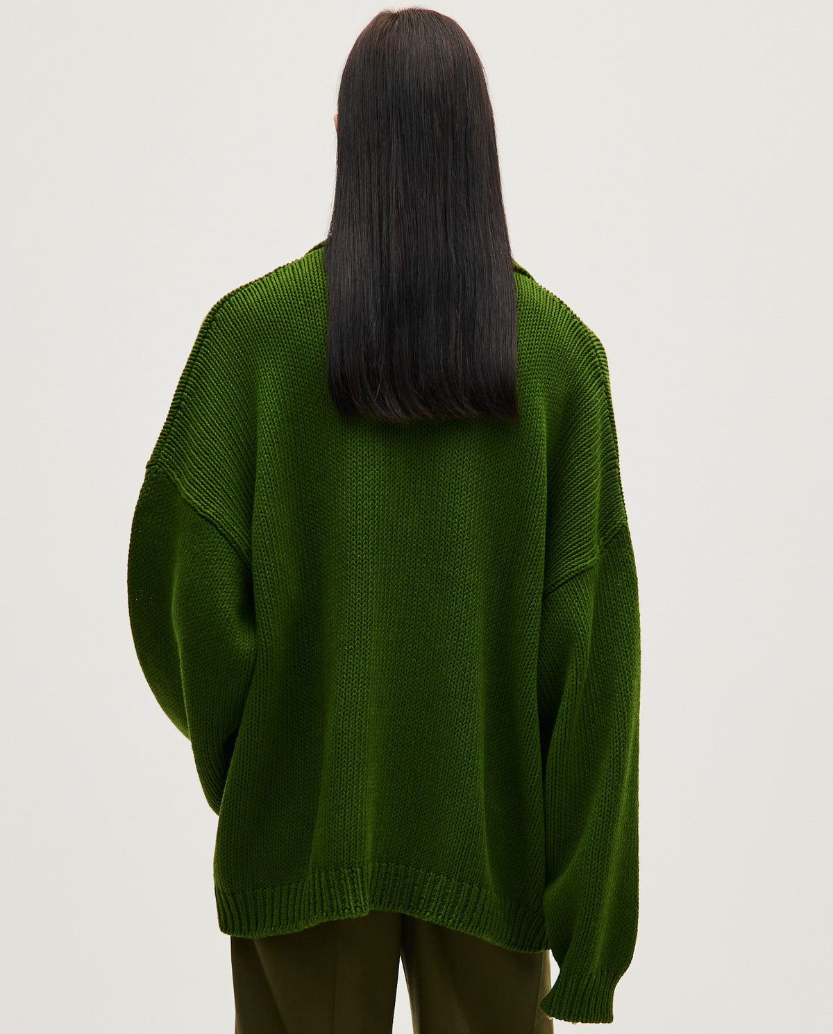 Woman wearing Babaà Polo No1 Pine in a casual fit, featuring a classic polo shirt in pine green color.