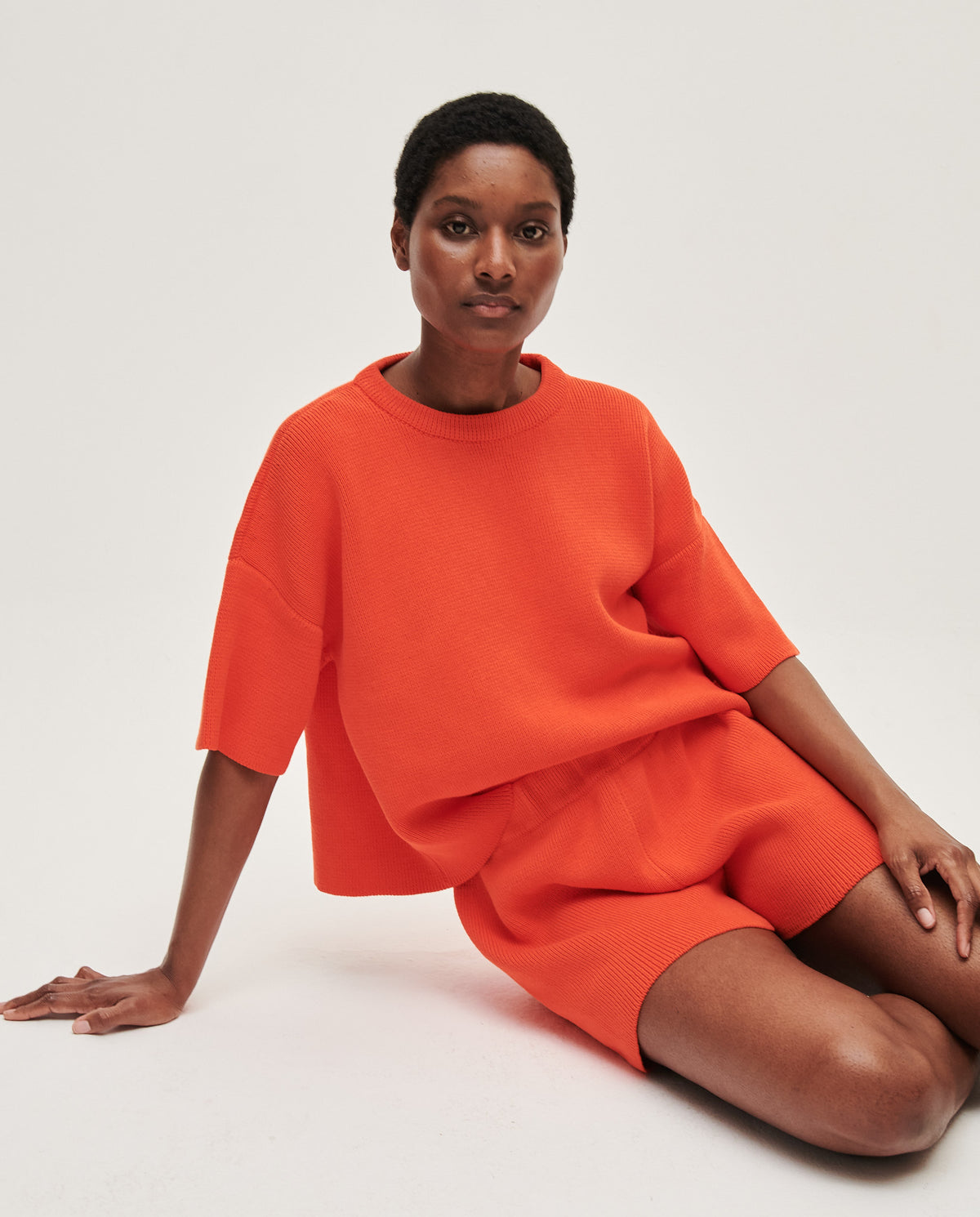 Babaà No35 Tangelo women's shorts in vibrant orange fabric, shown on a woman with a relaxed fit and stylish design.