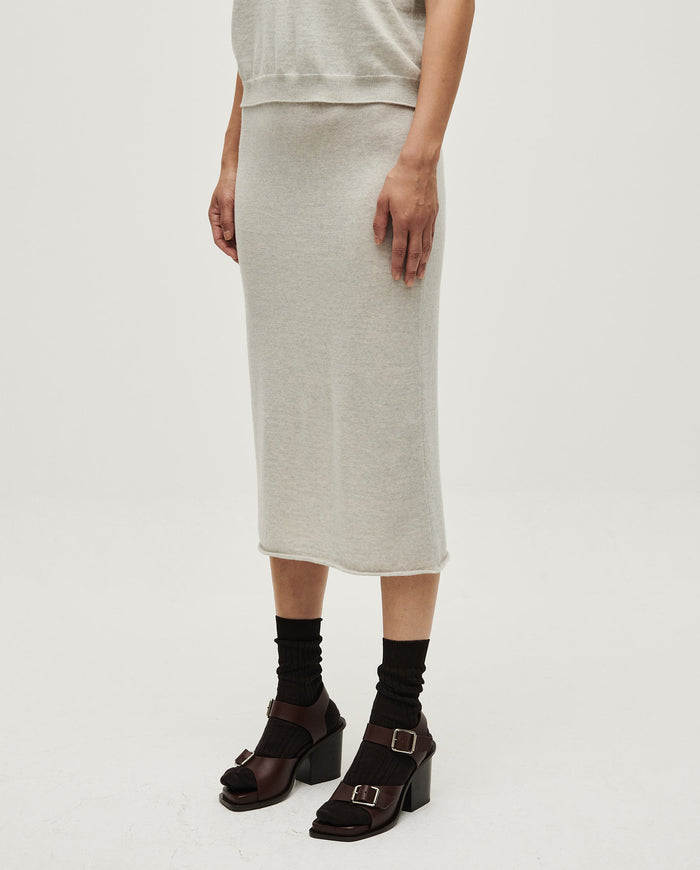 Woman wearing Babaà Skirt No25 Estrella with floral pattern and flowing fabric, styled for a casual or dressy look.