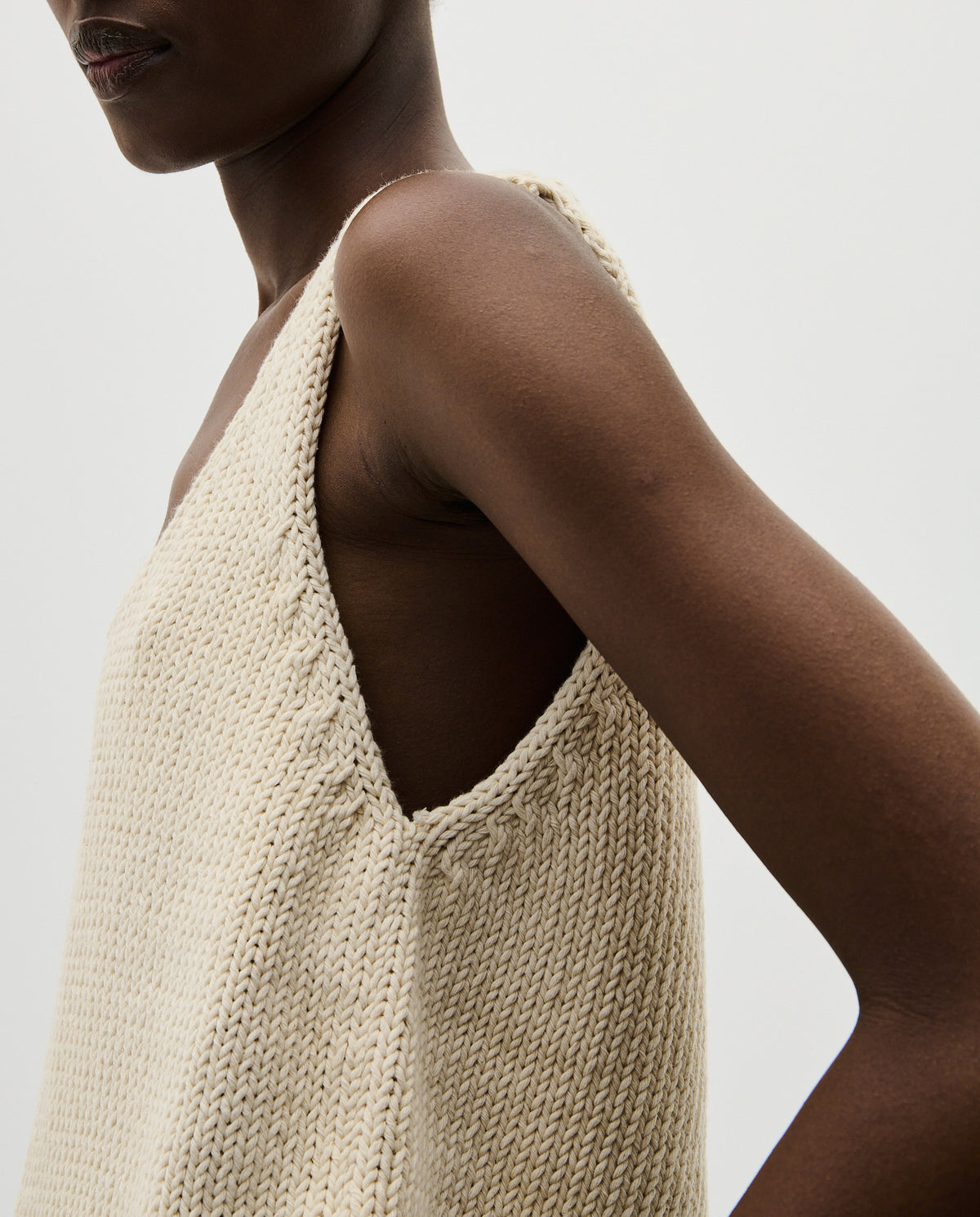 Woman wearing Babaà Top No1 Natural, stylish sleeveless top with a relaxed fit, made from soft, natural fabric.