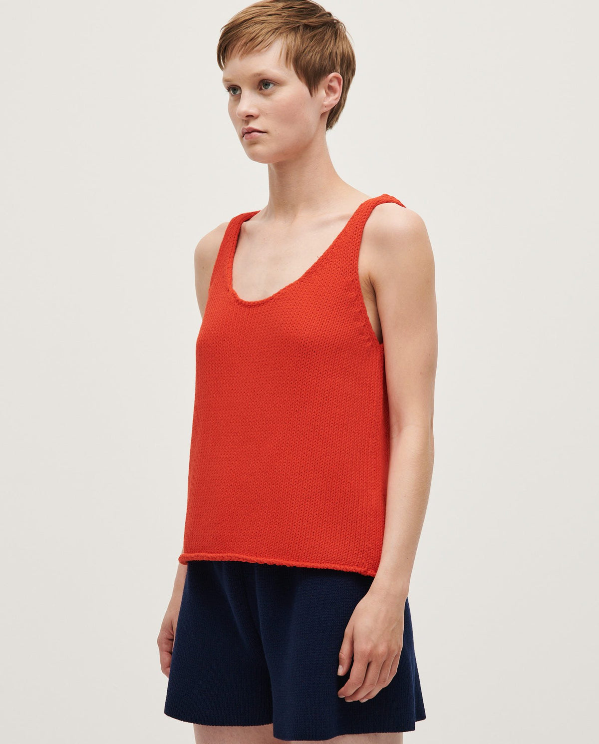 Woman wearing Babaà Top No1 Summer Flame, stylish sleeveless top with vibrant flame pattern, perfect for warm weather.