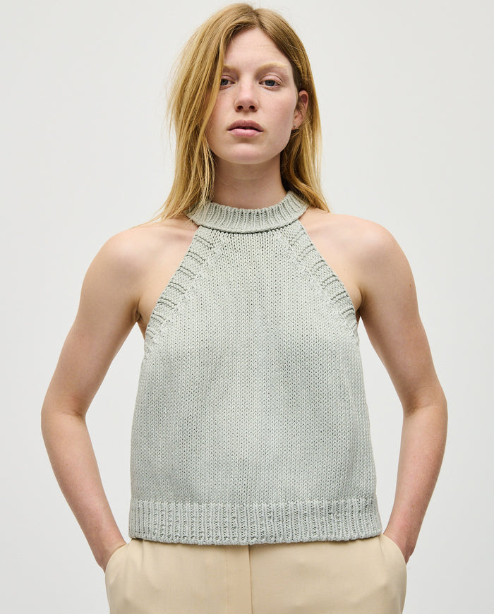 Woman wearing Babaà Top No2 Chalk, stylish sleeveless top with a fitted design, showcased in a fashion image.