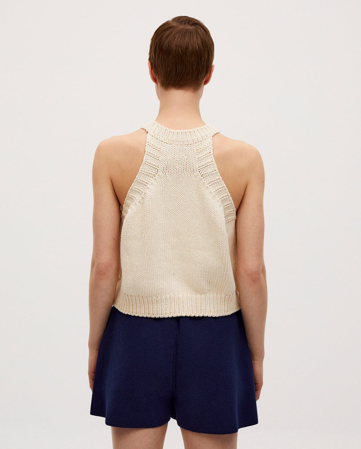 Woman wearing Babaà Top No2 Natural, a stylish and comfortable sleeveless top in a natural fabric, perfect for casual wear.