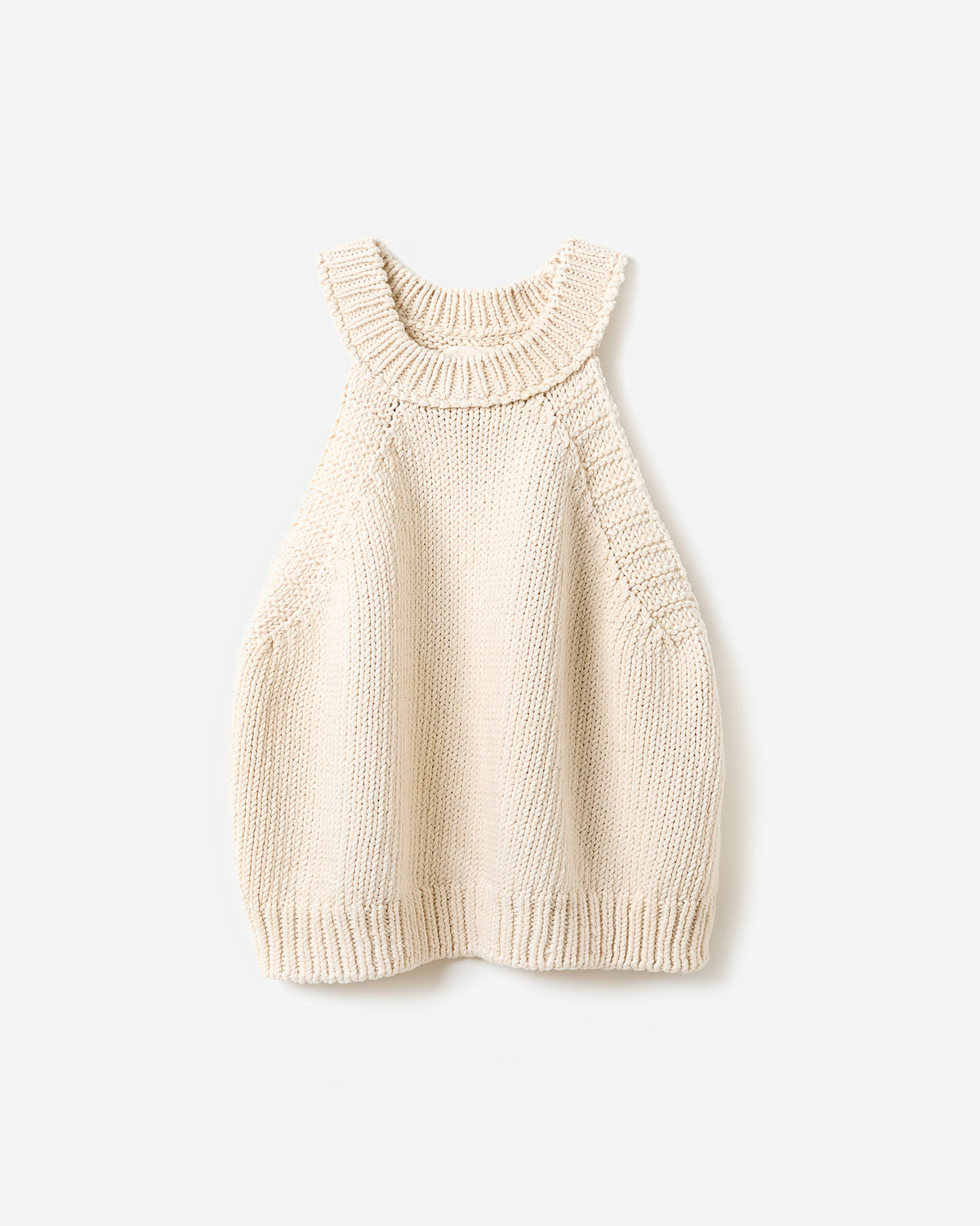 Woman wearing Babaà Top No2 Natural, stylish sleeveless top with a fitted silhouette in a natural fabric finish.