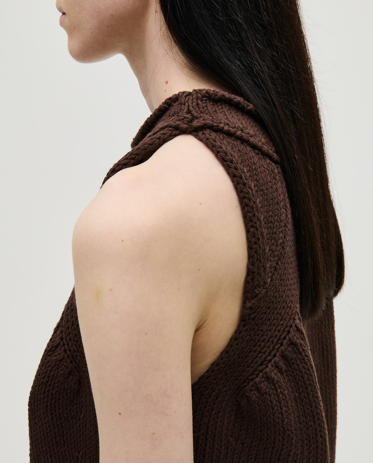 Woman wearing Babaà Top No46 Husk, a stylish sleeveless top with a relaxed fit and textured fabric.