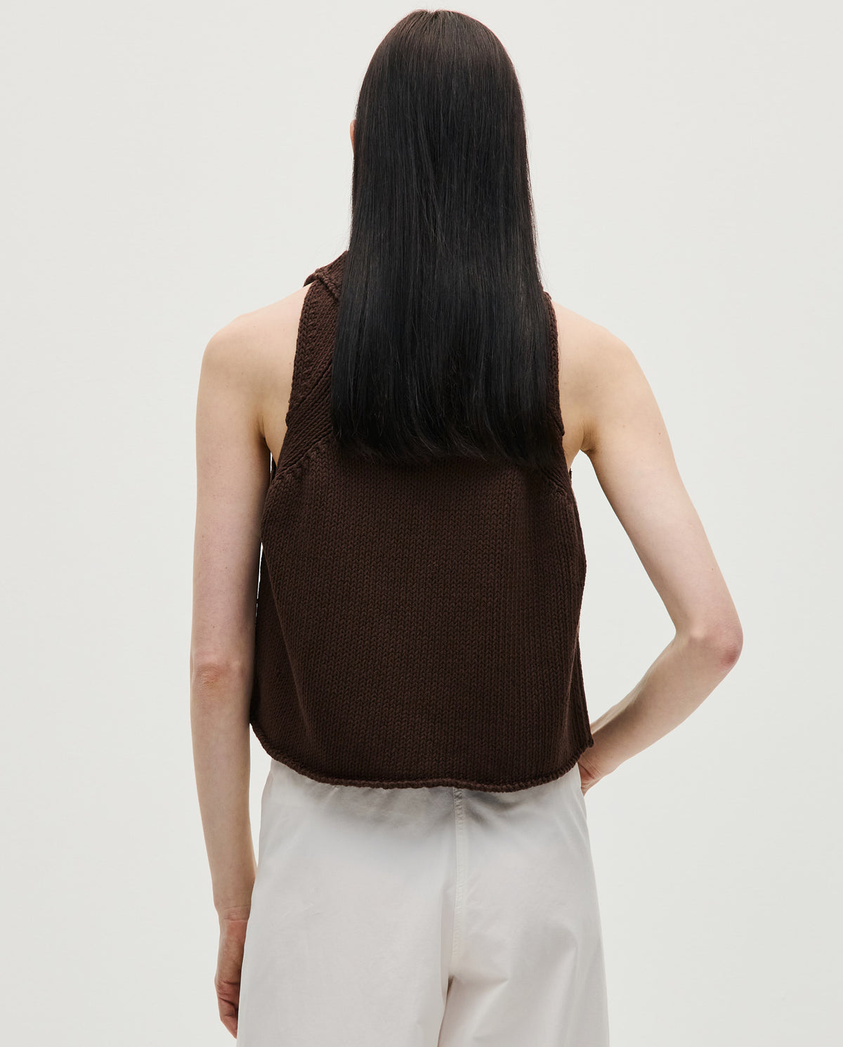 Woman wearing Babaà Top No46 Husk, stylish sleeveless top with textured fabric, perfect for casual and summer outfits.