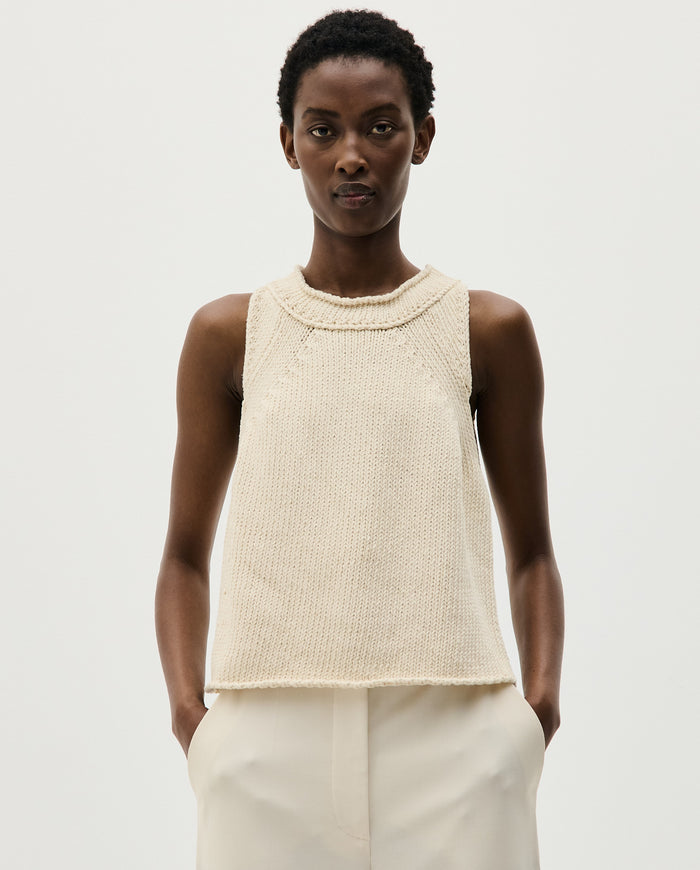 Woman wearing Babaà Top No46 Natural, showcasing a stylish, natural-colored sleeveless blouse with a relaxed fit.