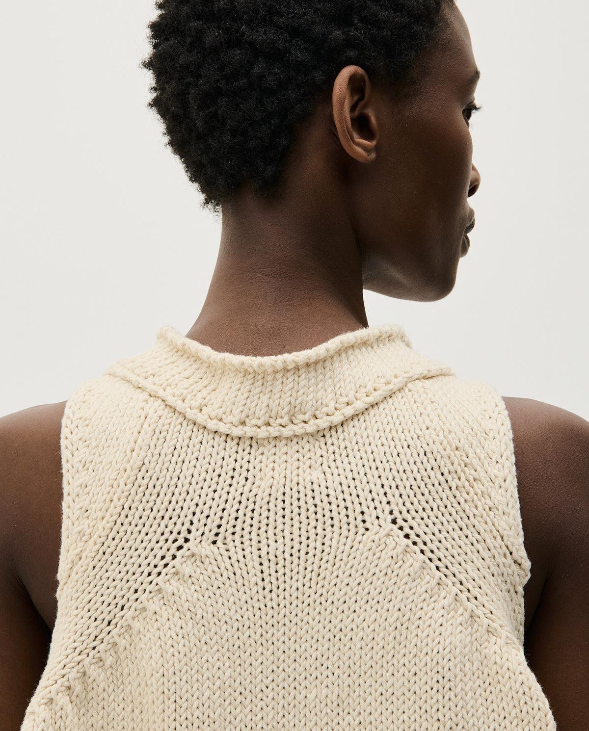 Woman wearing Babaà Top No46 in natural, featuring a comfortable and stylish sleeveless design with a relaxed fit.