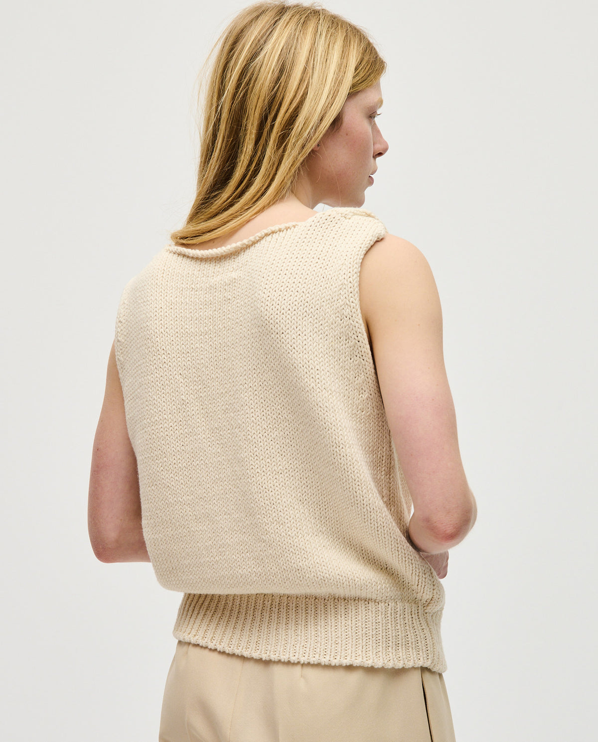 Woman wearing Babaà Top No88 Natural, a stylish sleeveless top with a relaxed fit and natural fabric texture.