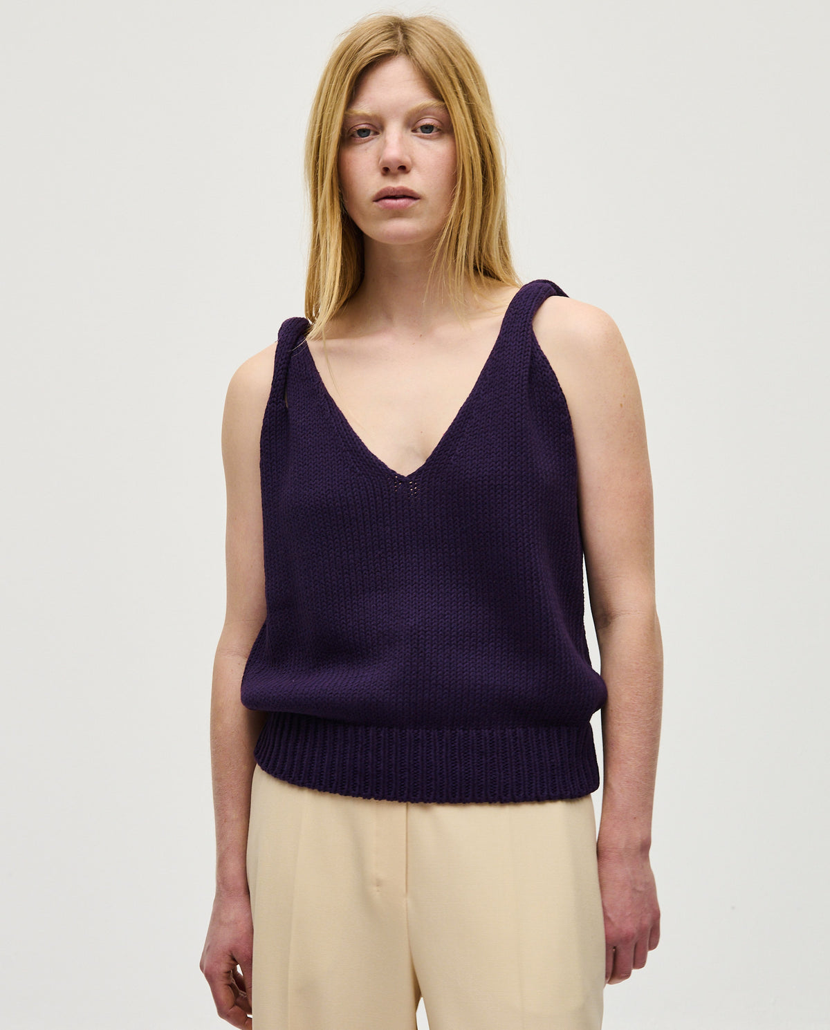 Woman wearing Babaà No88 Ridge top, stylish sleeveless blouse with a relaxed fit and textured fabric.