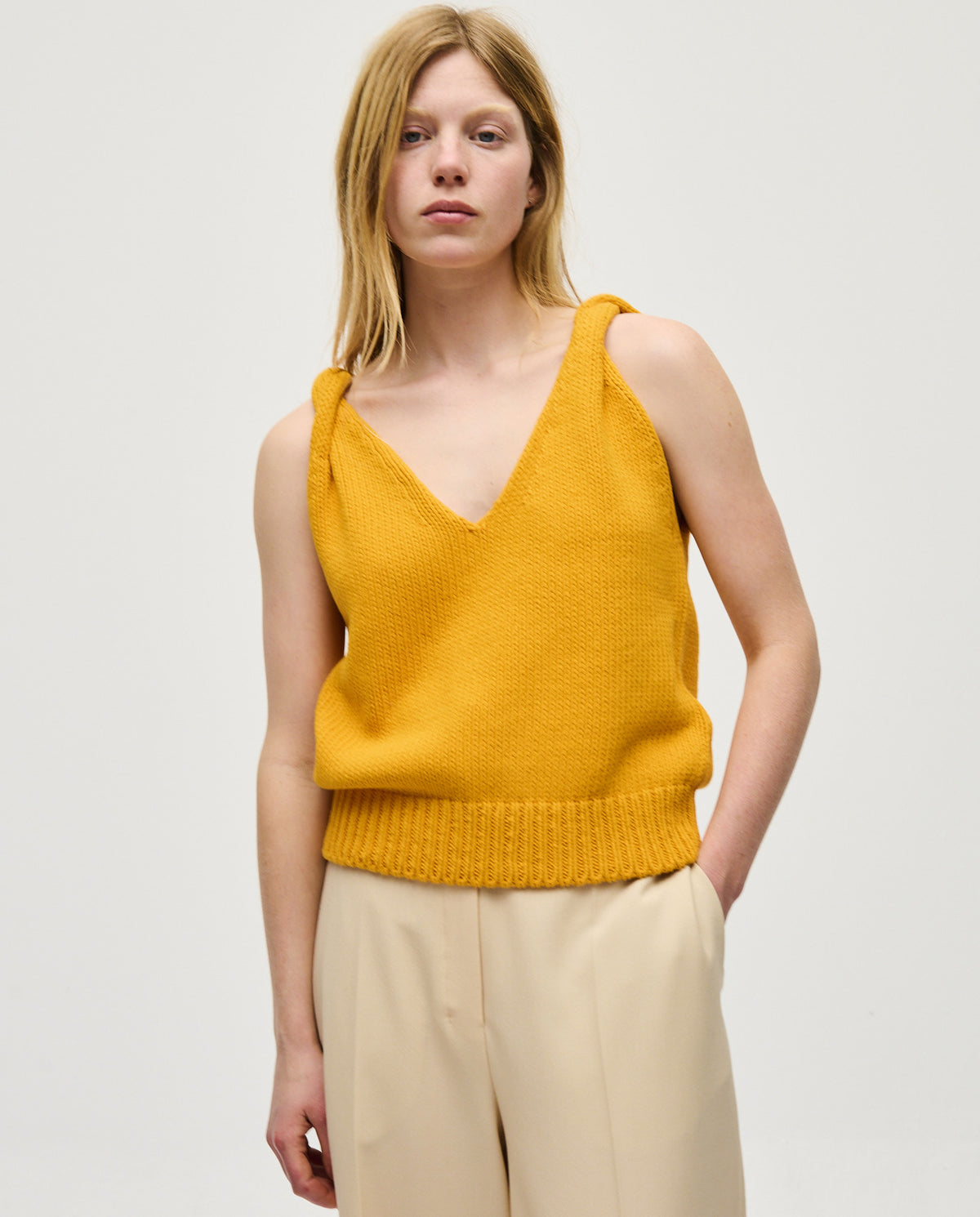 Babaà Top No88 Yolk for women, vibrant yellow sleeveless blouse with round neckline, styled on a woman.