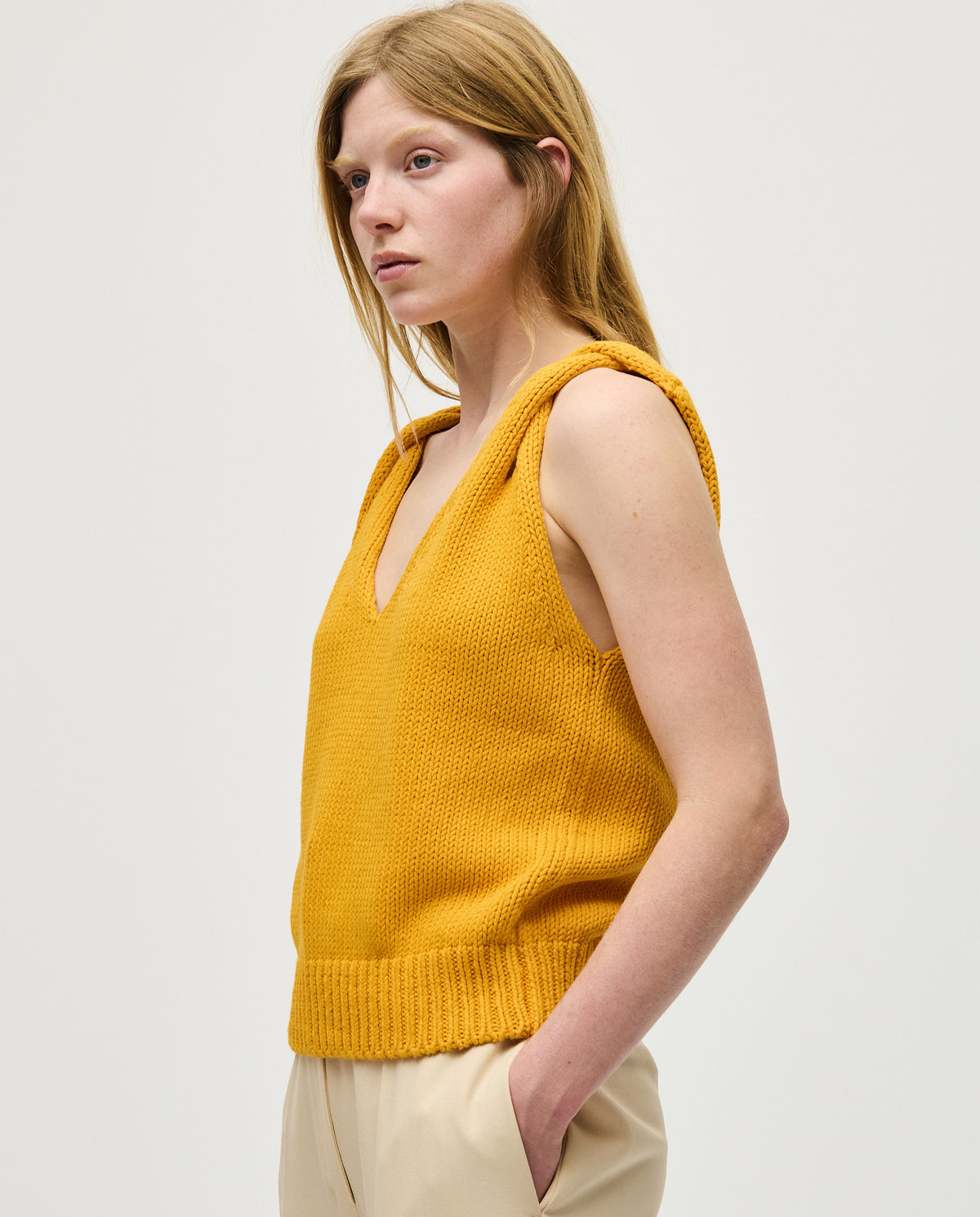 Babaà No88 Yolk women's top, stylish sleeveless design with a vibrant yellow color, worn by a woman in the image.