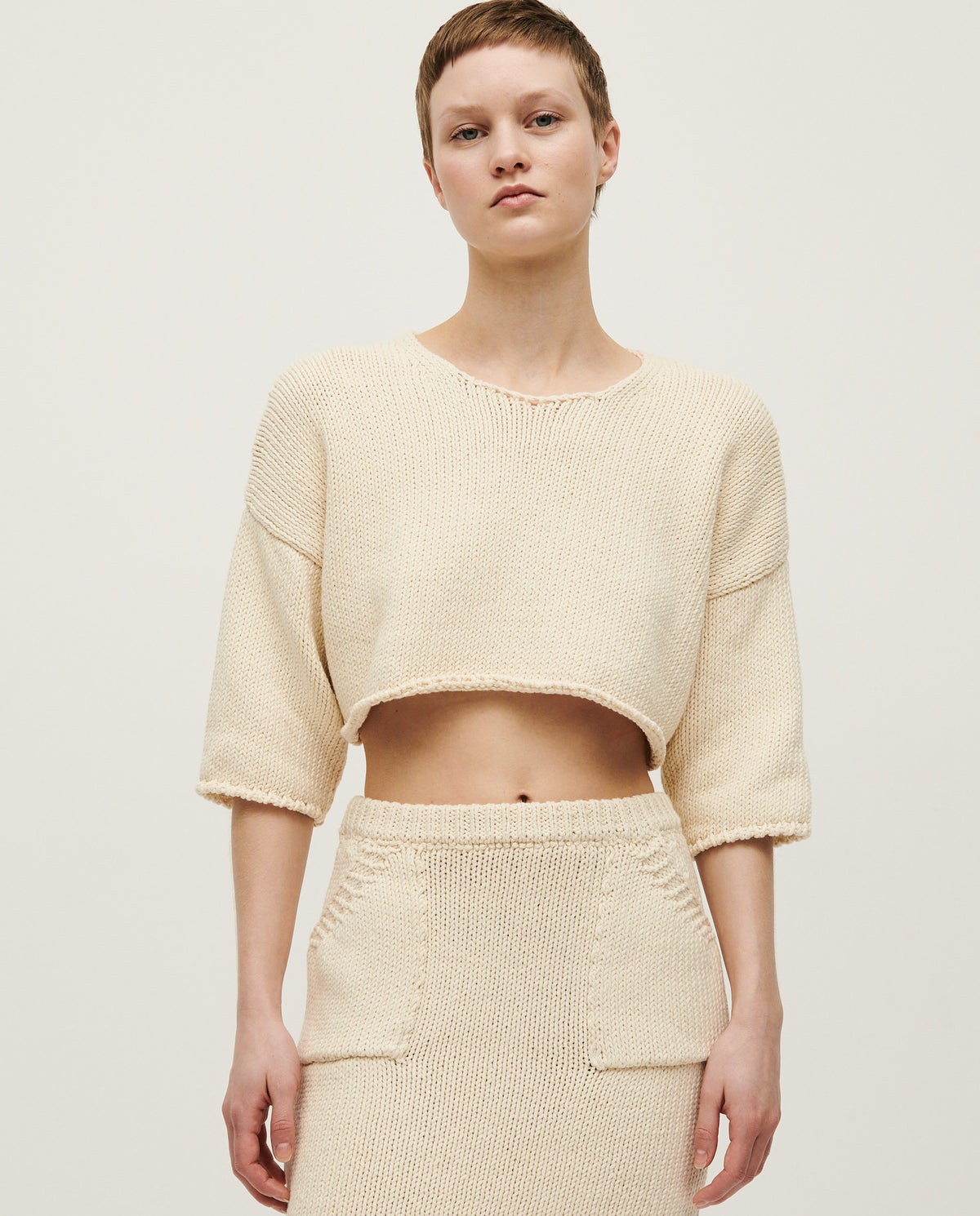 Woman wearing Babaà Top No9 Natural, stylish sleeveless top with a relaxed fit and neutral color, ideal for casual wear.