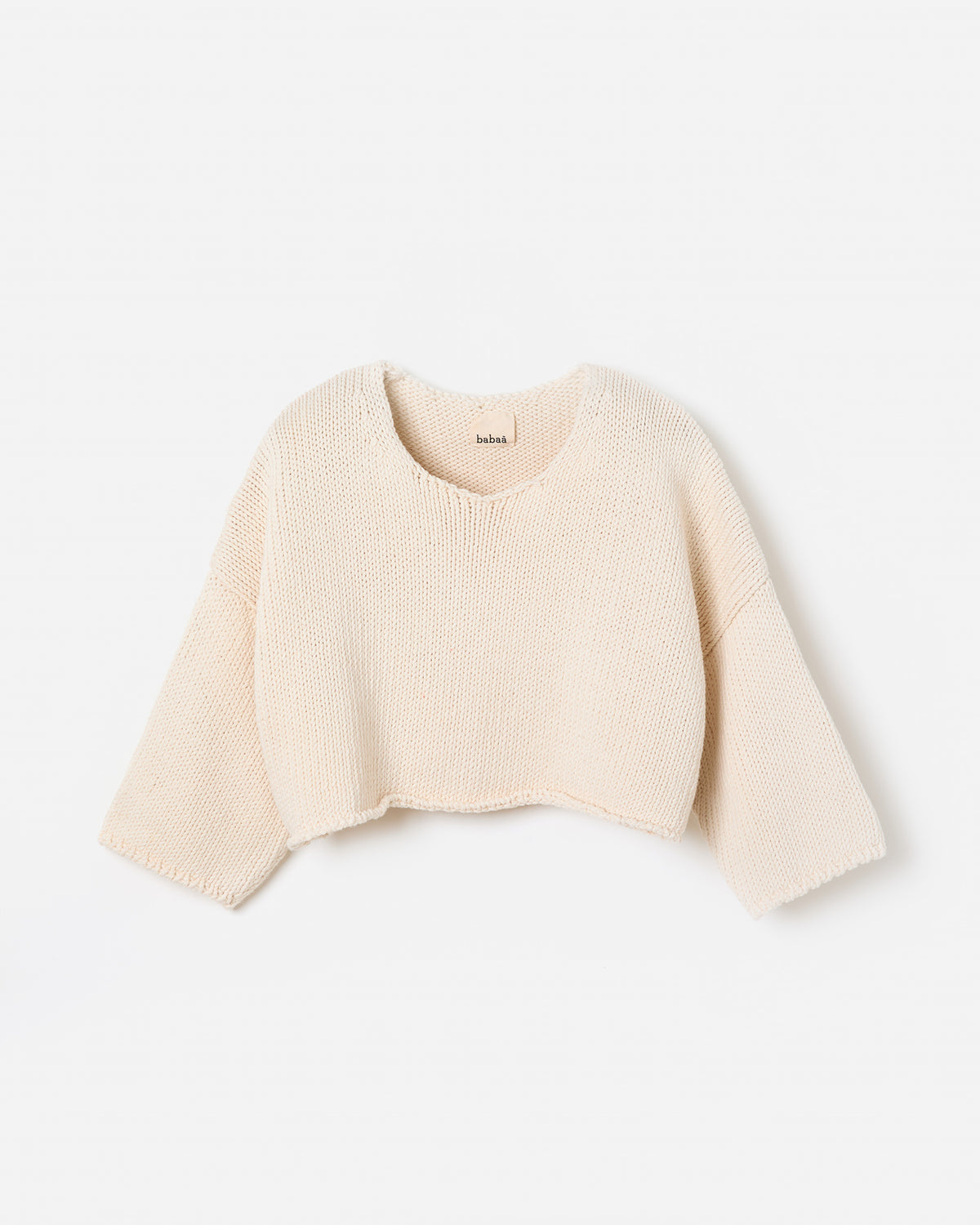 Woman wearing Babaà Top No9 Natural, featuring a relaxed fit and soft fabric, shown in a side silhouette.