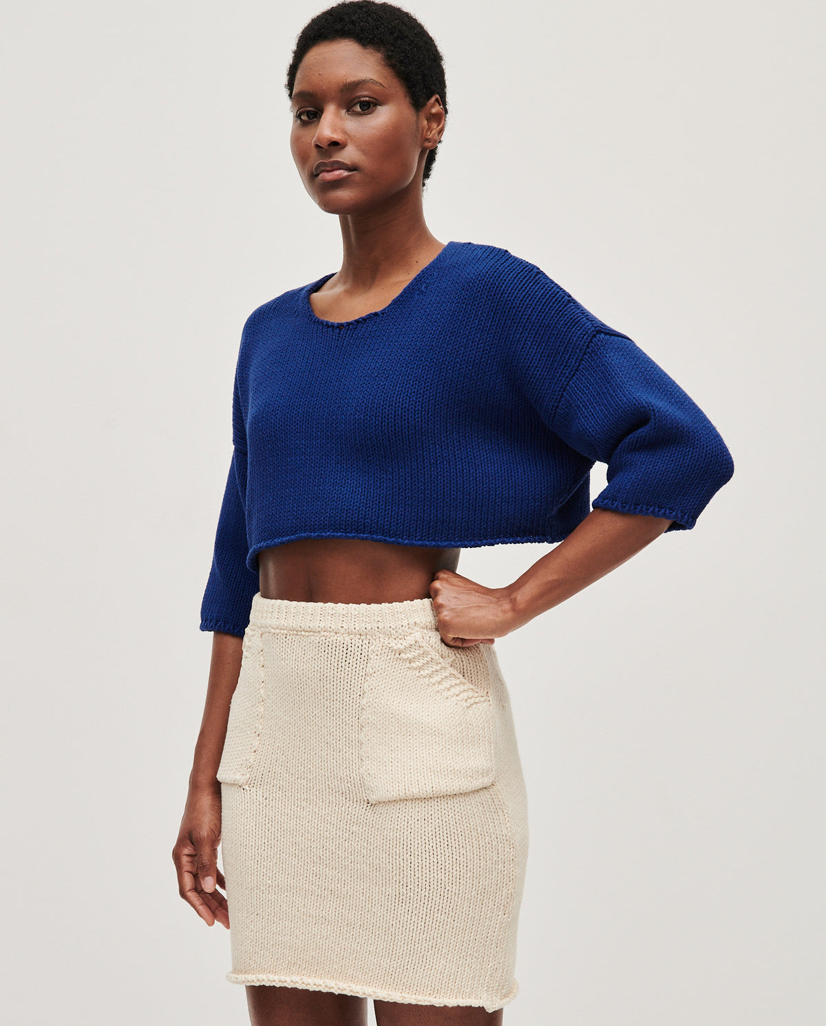 Babaà Top No9 Puddle worn by a woman, featuring a stylish, draped design with a puddle hem, in a neutral color.