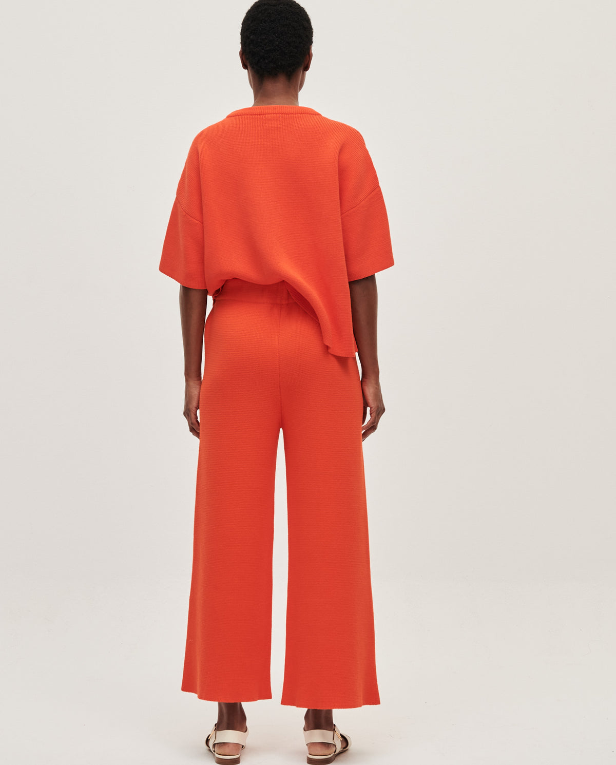 Babaà No35 Tangelo women's trousers featuring a vibrant orange color and tailored fit, shown laid flat on a white background.