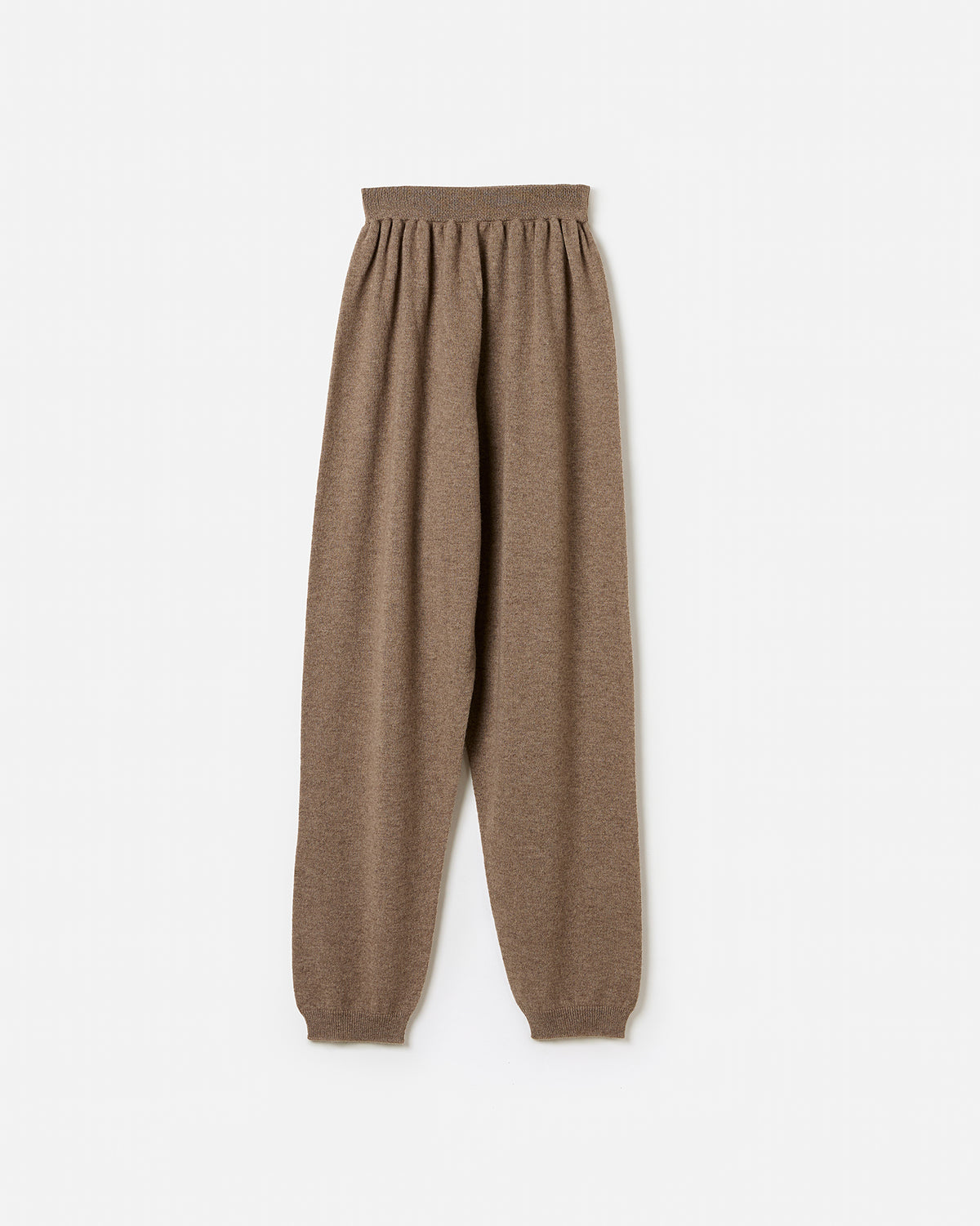 Woman wearing Babaà no41 limestone trousers, showcasing their relaxed fit and soft linen fabric in a natural outdoor setting.