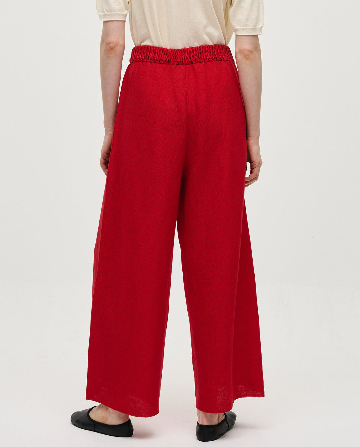 Red Babaà No60 women's trousers displayed on a model, showcasing the stylish fit and vibrant color.