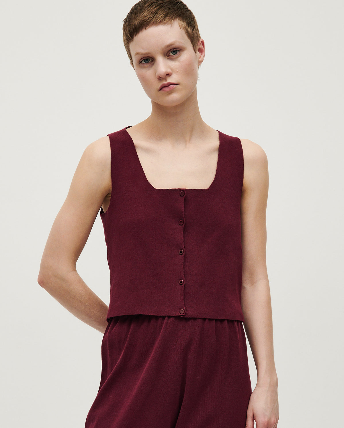 Babaà No39 cherry vest for women, showing a close-up of the stylish red vest styled with casual clothing.