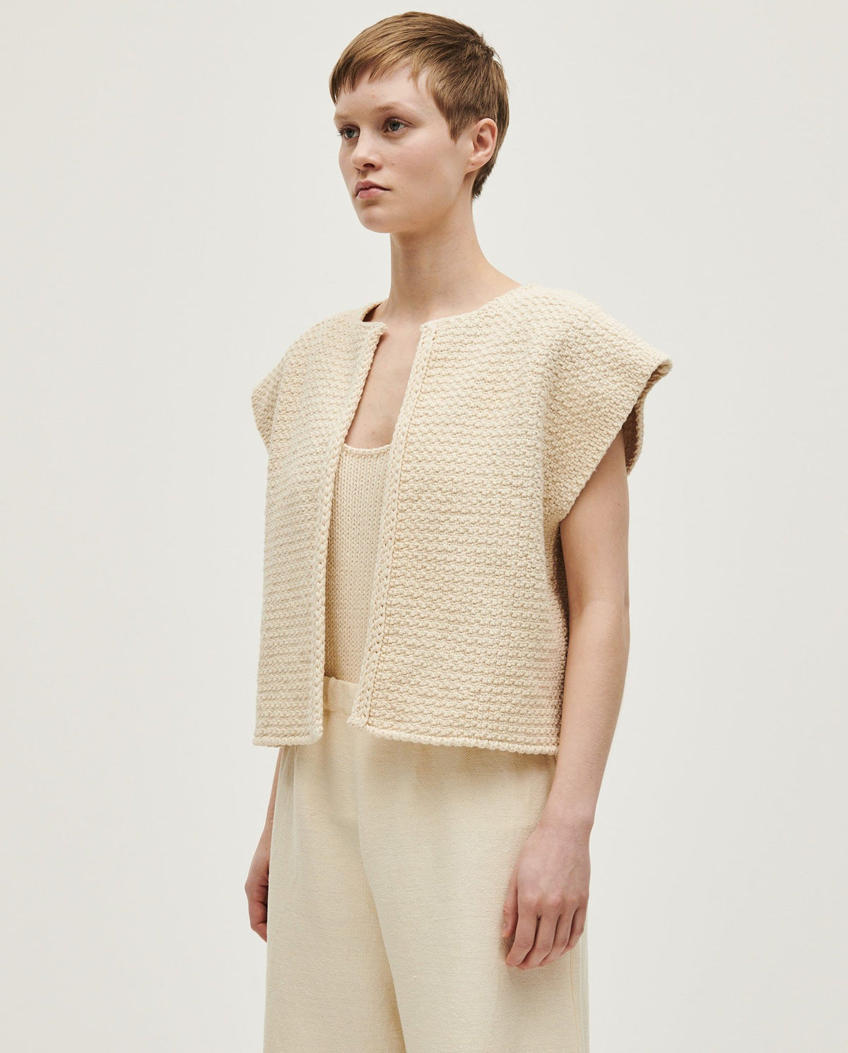 Woman wearing Babaà No8 Natural vest, soft and lightweight sleeveless top with a relaxed fit, styled for casual wear.